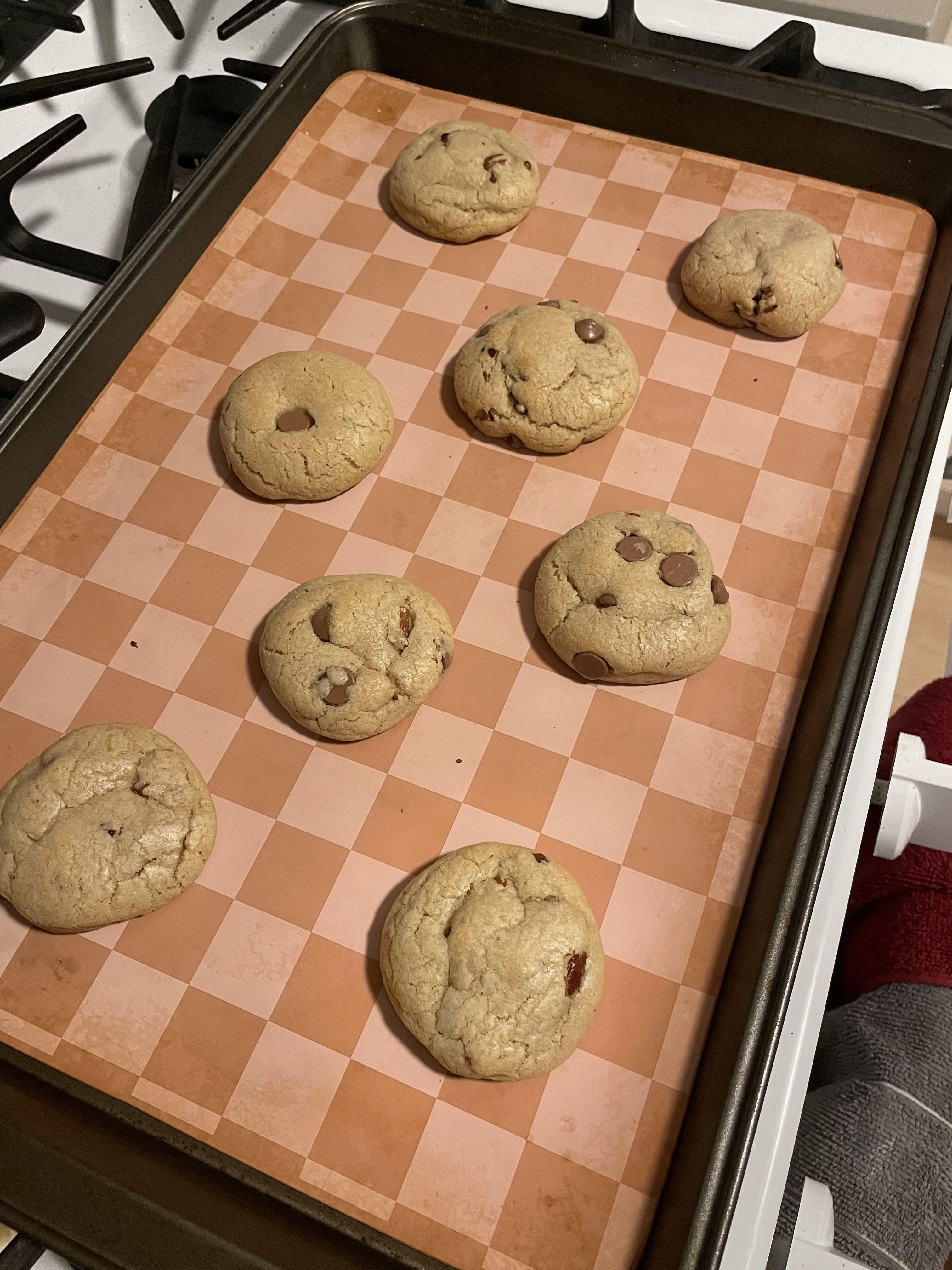 Freshly baked cookies on a checkered baking sheet.